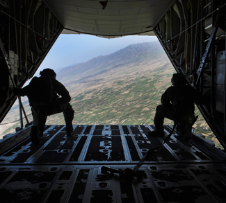 Air Force loadmasters watch pararescuemen descend to the drop zone after jumping from a C-130J Super Hercules aircraft during a mission rehearsal at Bagram Airfield, Afghanistan, April 28, 2016. Air Force photo by Senior Airman Justyn M. Freeman