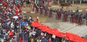 cc VOA Burma, public domain, https://commons.wikimedia.org/wiki/File:Protesters_against_the_military_coup.jpg, modified,