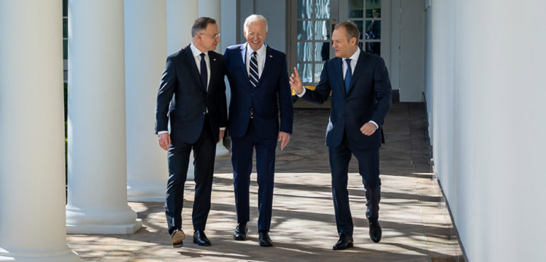 President Joe Biden walks along the West Colonnade of the White House with President Andrzej Duda and Prime Minister Donald Tusk of Poland, Tuesday, March 12, 2024., cc White House, modified, https://commons.wikimedia.org/w/index.php?search=biden%20poland&ns0=1&ns6=1&ns12=1&ns14=1&ns100=1&ns106=1#/media/File:President_Joe_Biden_walks_along_the_West_Colonnade_of_the_White_House_with_President_Andrzej_Duda_and_Prime_Minister_Donald_Tusk_of_Poland,_Tuesday,_March_12,_2024.jpg