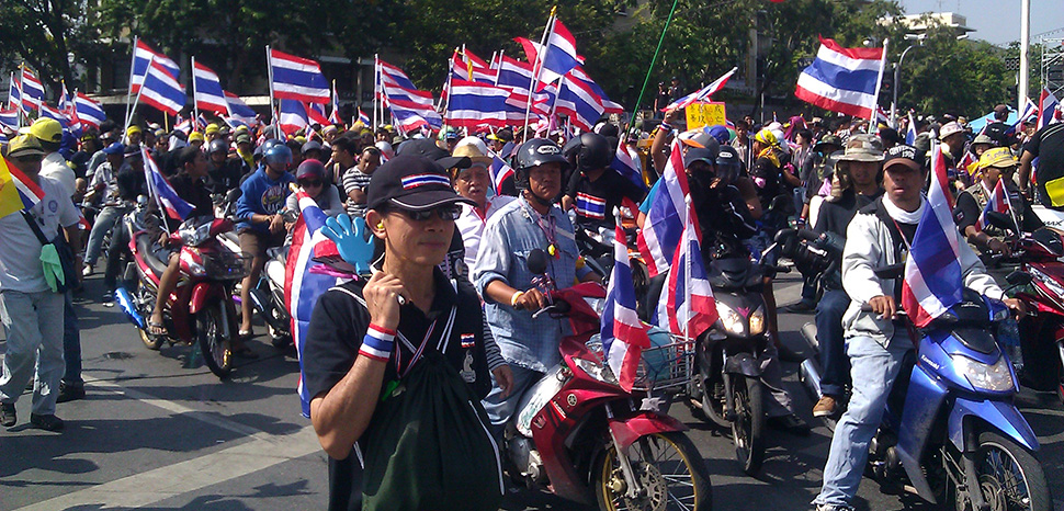 cc ilf_, modified, wikicommons. Anti-government protesters in Bangkok, on motorcycles while mobilizing to surround government offices, 1 December 2013 - the crisis that resulted in the removal of Yingluck Shinawatra.