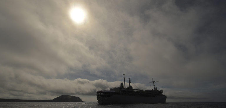 cc COMSEVENTHFLT, modified, WATERS TO THE SOUTH OF JAPAN (April 2, 2015) - Sailors assigned to the submarine tender USS Frank Cable (AS 40) man the rails as they pass Mount Suribachi following a wreath-laying ceremony commemorating the 70th anniversary of the Battle of Iwo Jima. The ceremony honored those who fought in the battle and included personal testimony from Sailors who had family fight in the battle, laying of a wreath, a 21-gun salute and the playing of taps. Frank Cable, forward deployed to the island of Guam, conducts maintenance and support of submarines and surface vessels deployed in the U.S. 7th Fleet area of responsibility and is currently on a scheduled underway period. (U.S. Navy photo by Mass Communication Specialist 2nd Class Greg House)